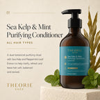 Theorie Sage Sea Kelp & Mint Purifying Conditioner bottle with greenery on a beige background