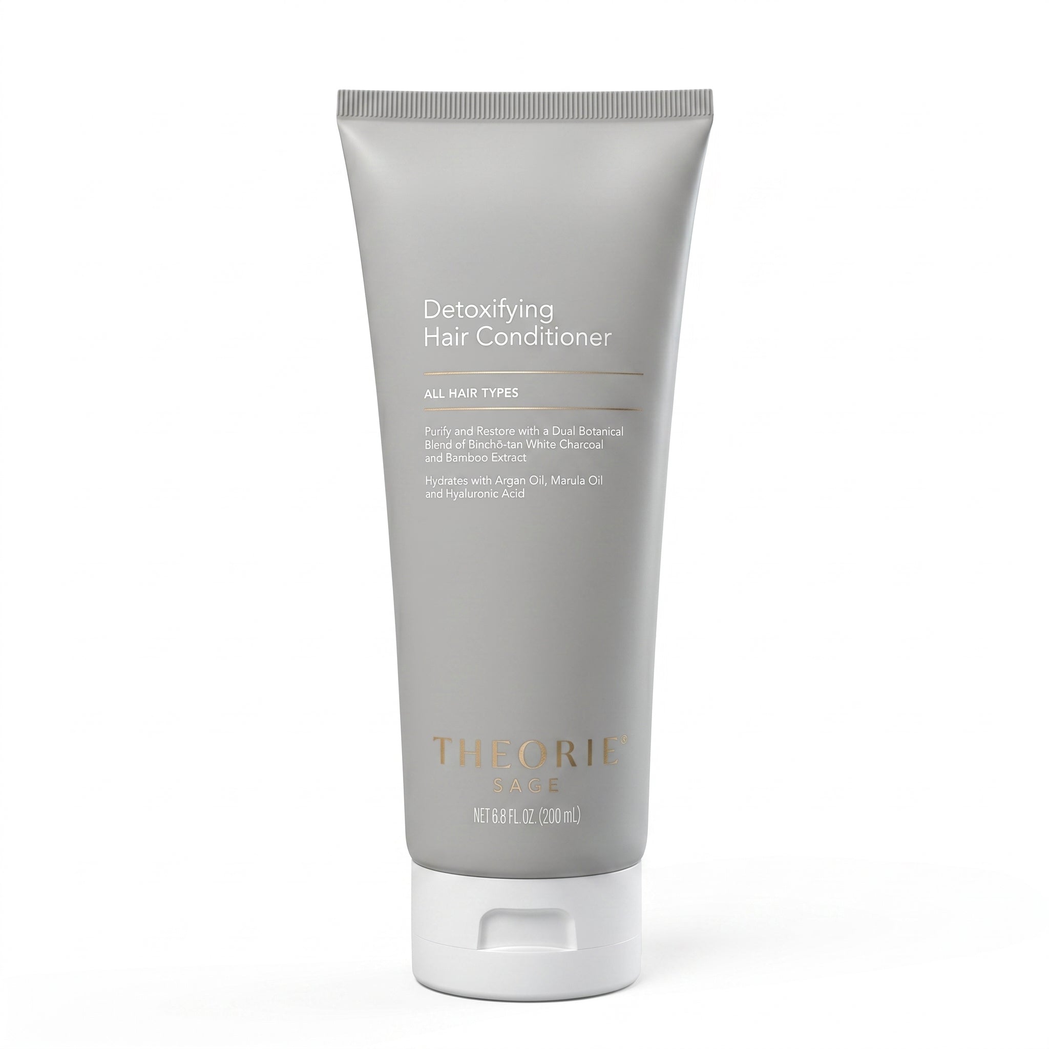 Detoxifying hair conditioner tube with 'Theorie' branding on a white background