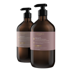Two bottles of Theorie hair care products on a white background